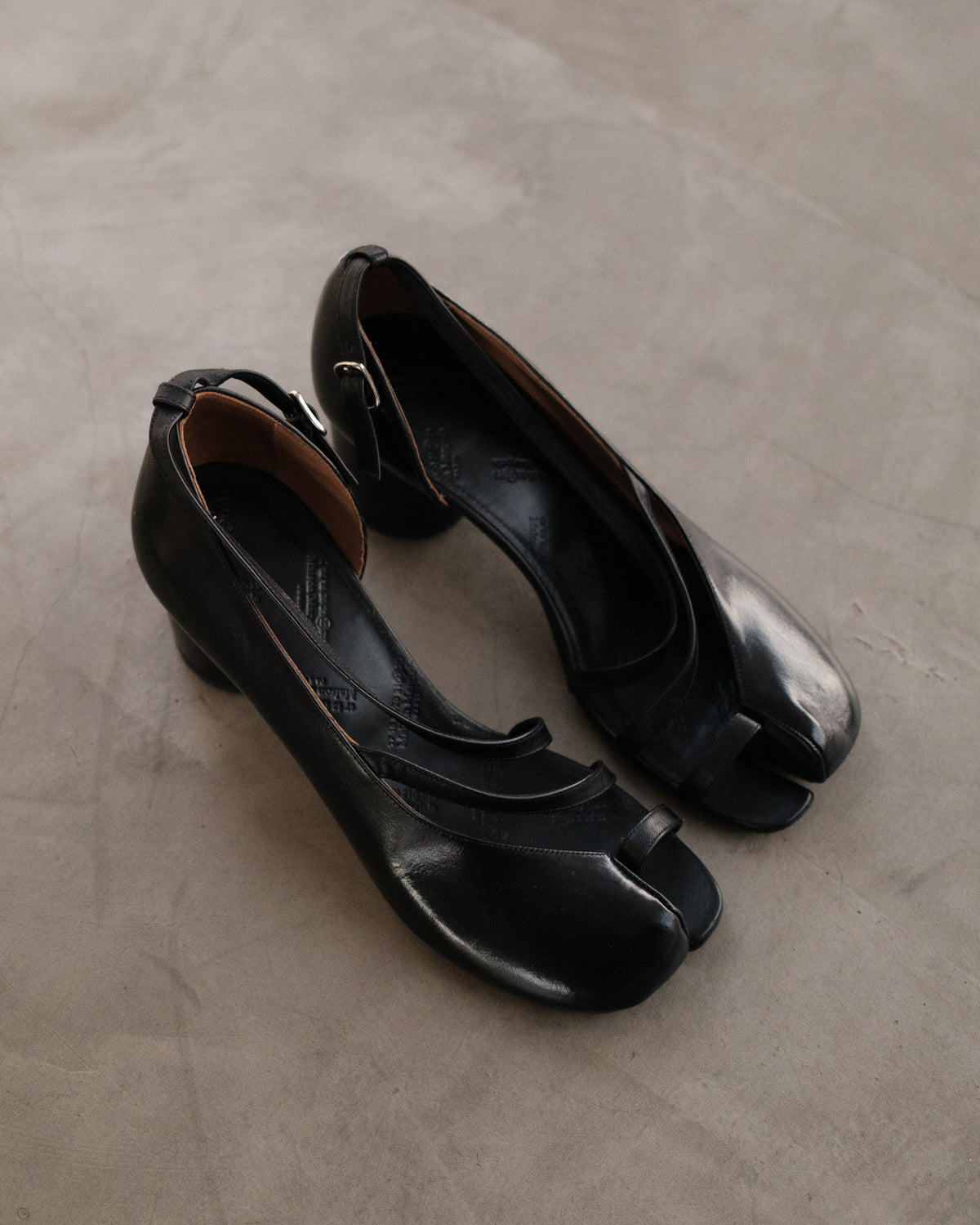 MAISON MARGIELA
Exclusive Black Exposed Toe Ankle Strap Tabi Sandals.