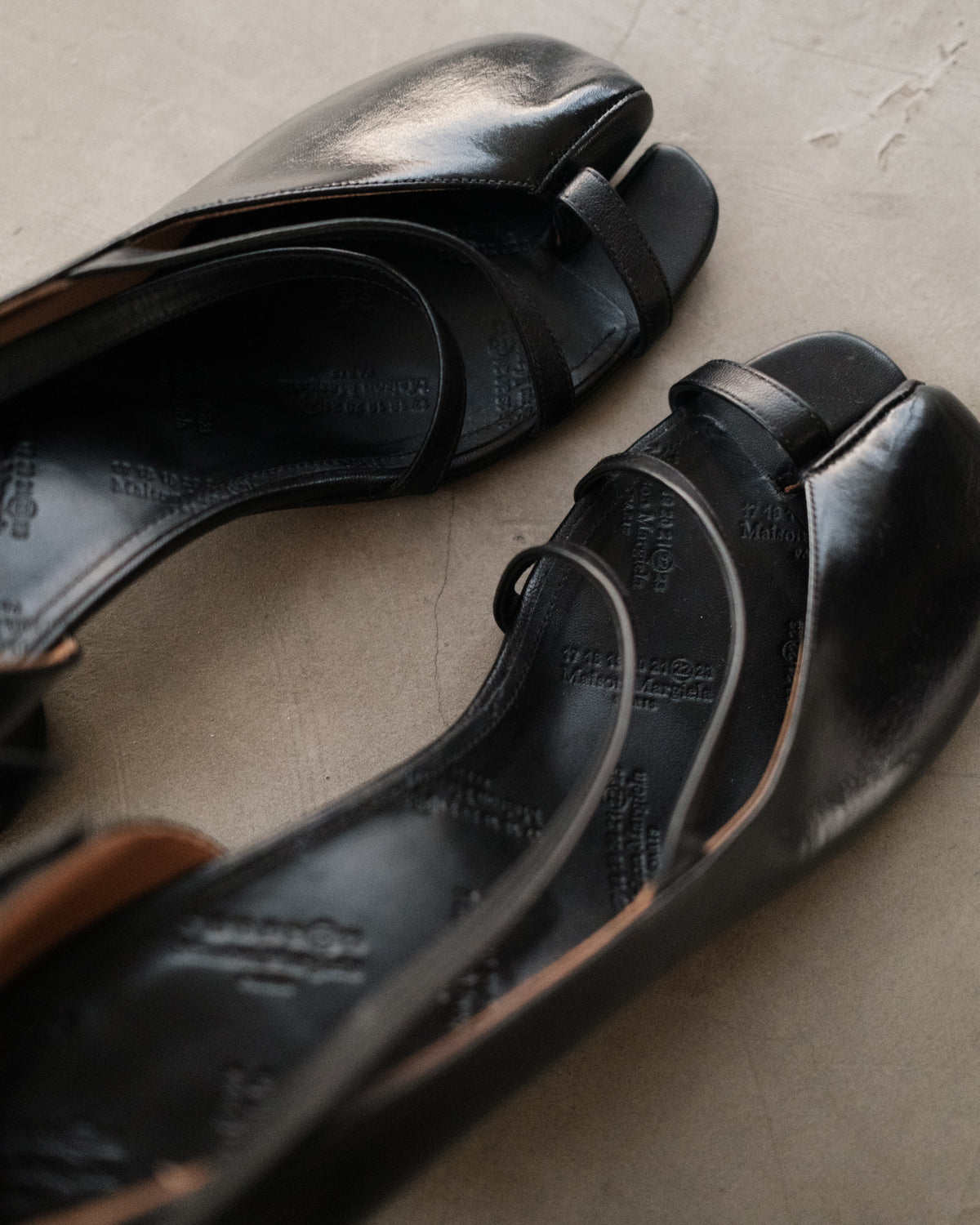 MAISON MARGIELA
Exclusive Black Exposed Toe Ankle Strap Tabi Sandals.